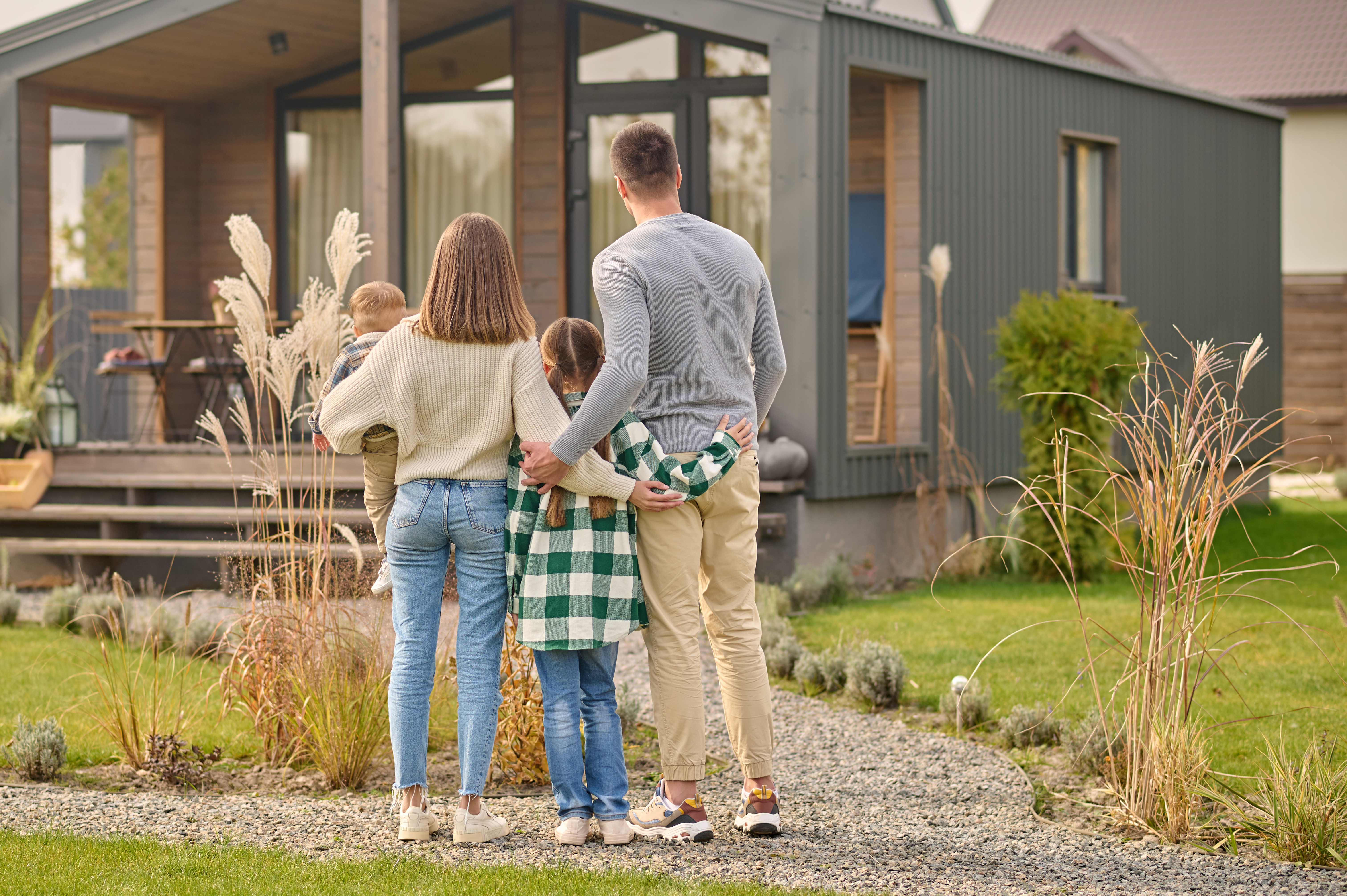 family admiring their home